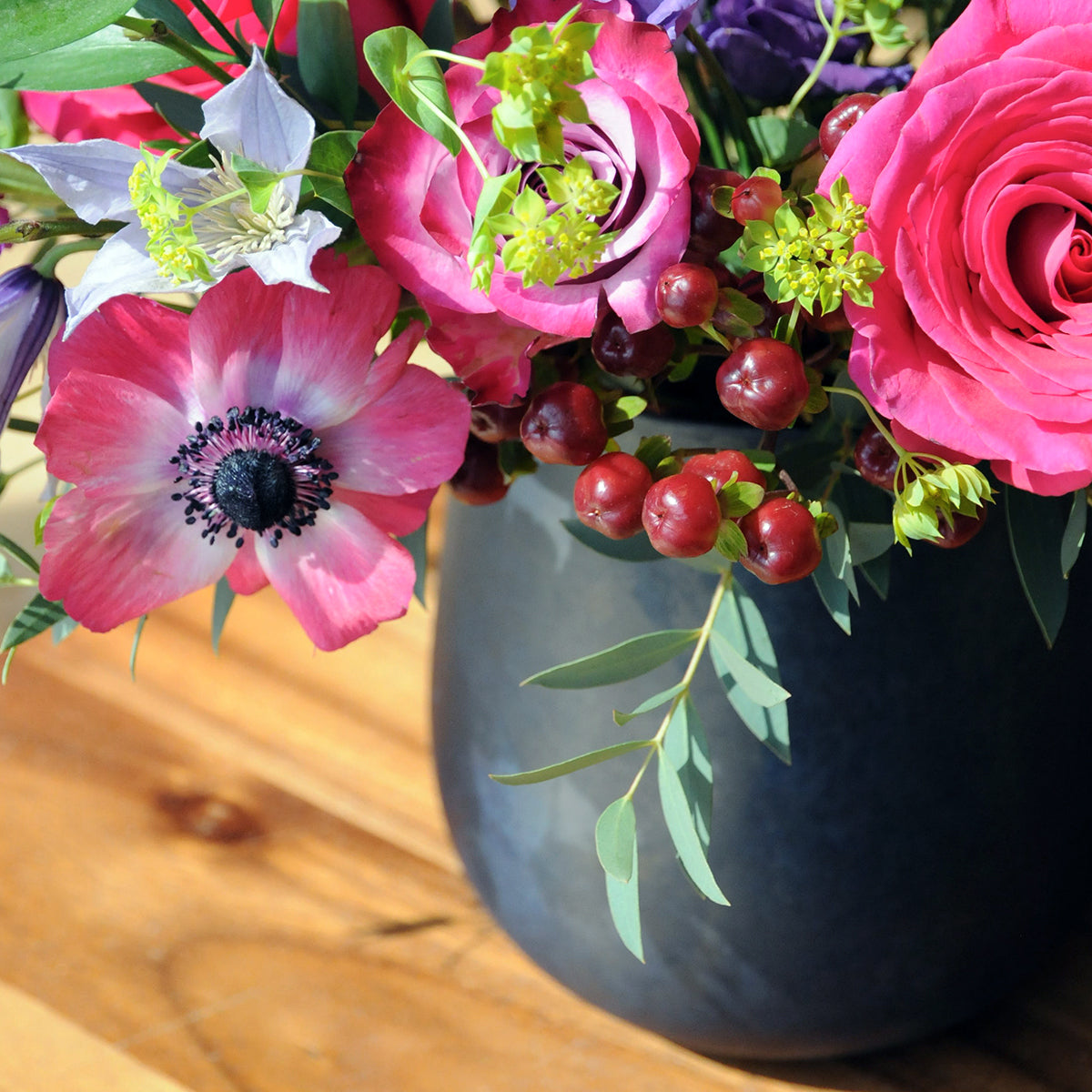 Detail image of Aldrich fkloral arrangement showing the color of the blue raindrop vase