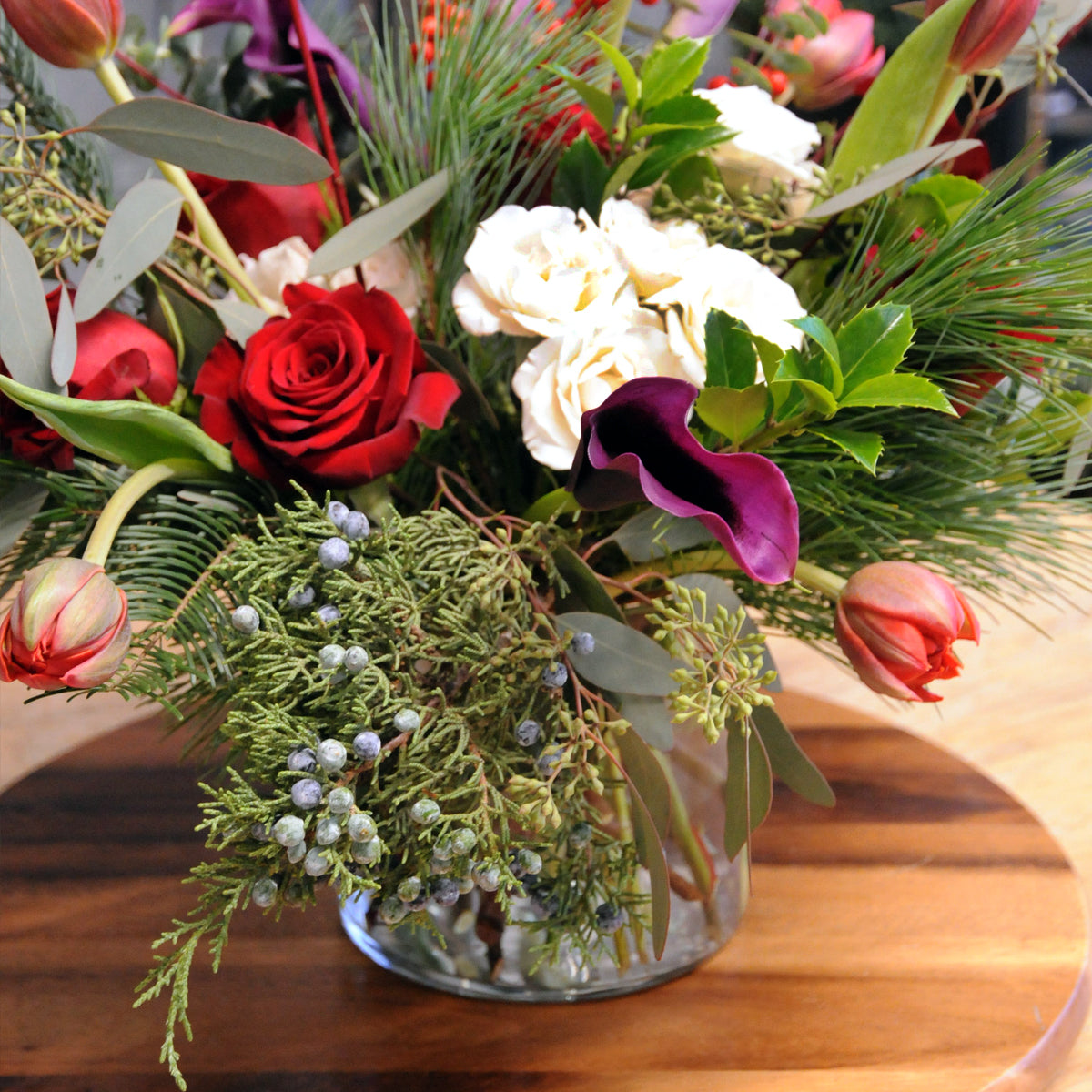 part of our winter collection our statement Armatage floral arrangement features textural greens and festive florals