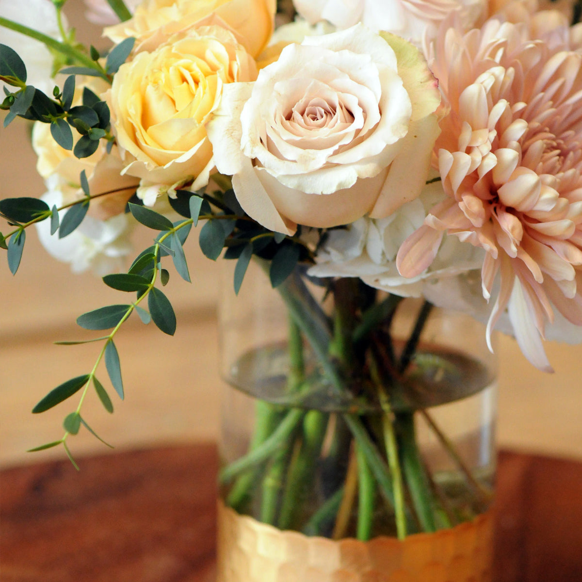 Detail view of Sahara Spray roses and eucalyptus foliage