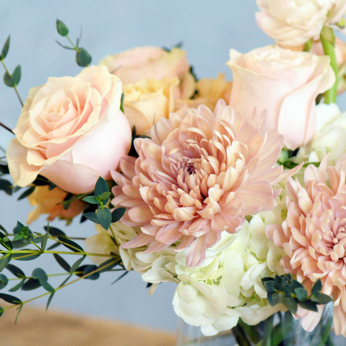 Close up of France Avenue florals shown in peach and pink tones
