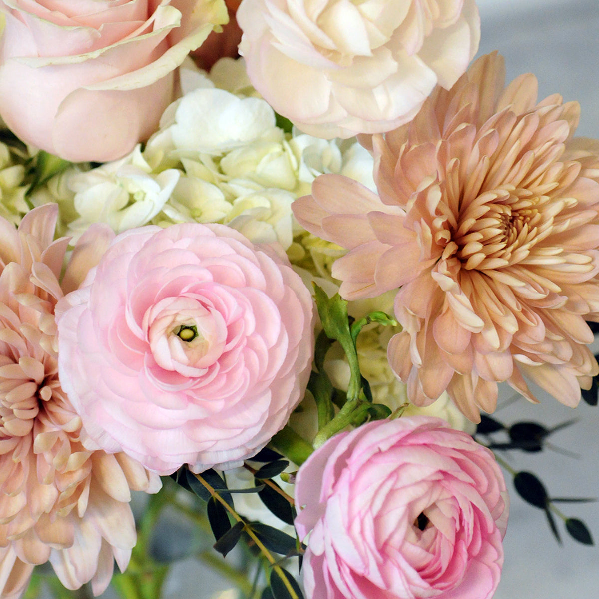 Close up of pink and peach florals in Spruce Flowers France Ave Arrangement for delivery in the St paul and Minneapolis Metro area.