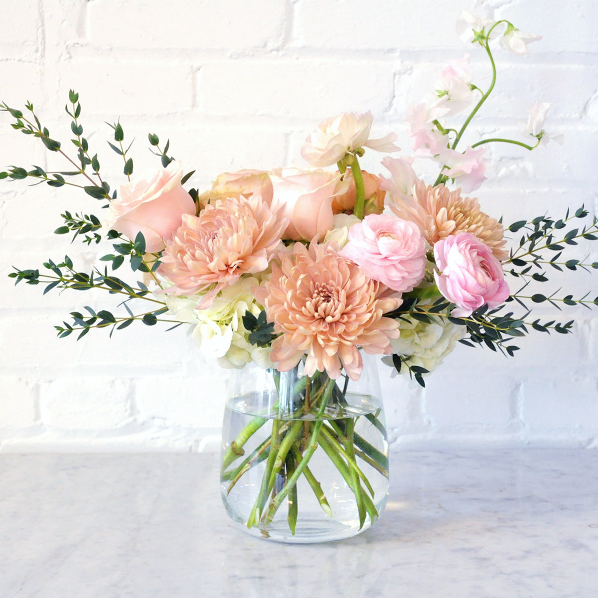 Spruce Flowers - France Avenue floral arrangement shown in a clear glass Raindrop vase perfect for a valentines gift.