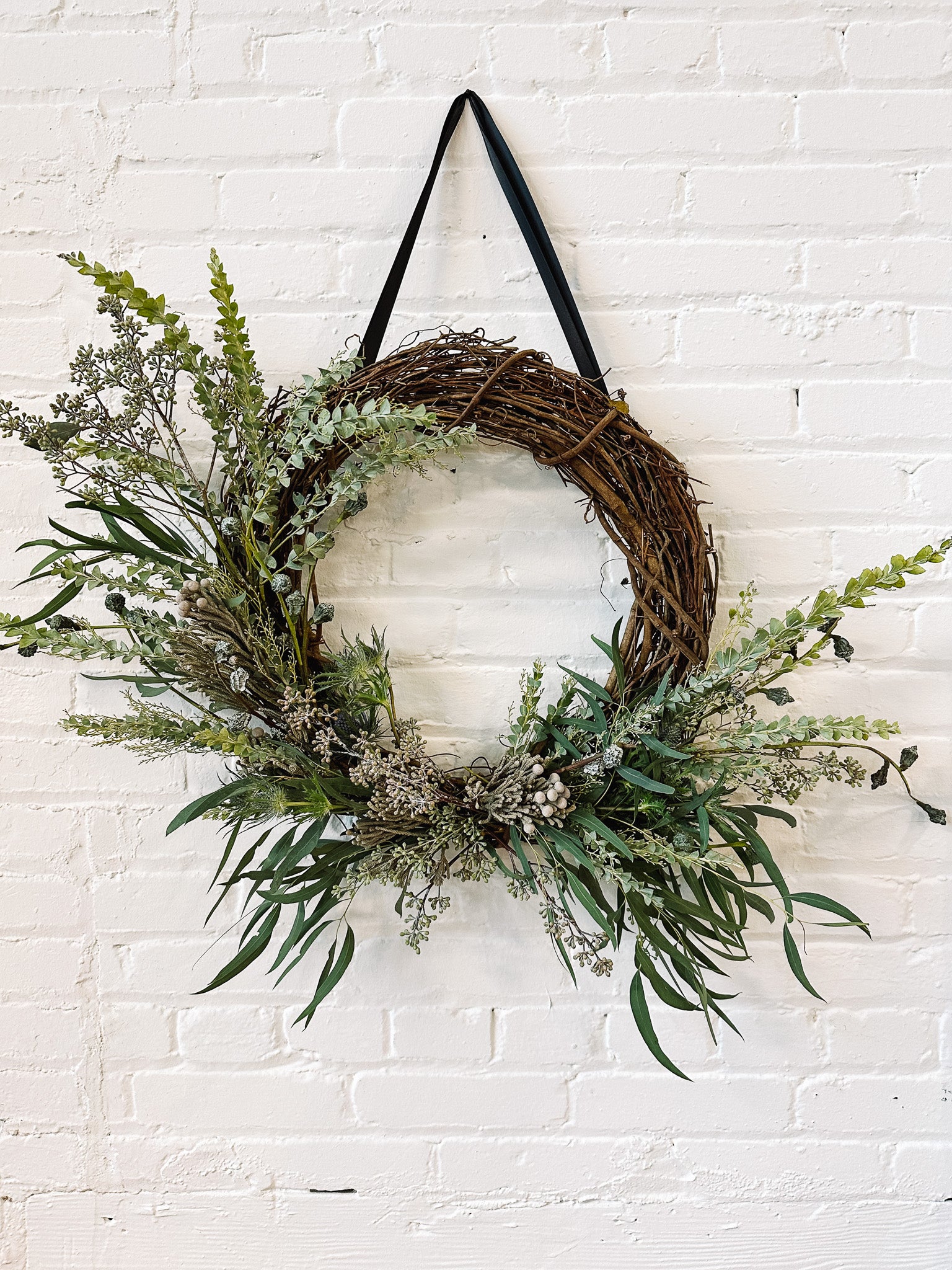 Vine Wreath on brick wall with fresh accents