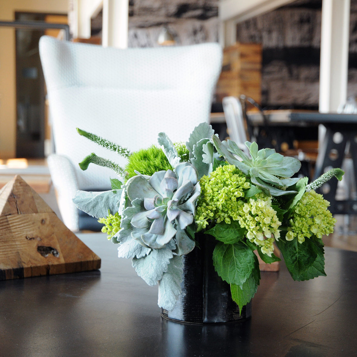 Spruce Flowers medium sized Loring floral arrangement with its textural mix of monochromatic green flowers with white accents of Veronica.