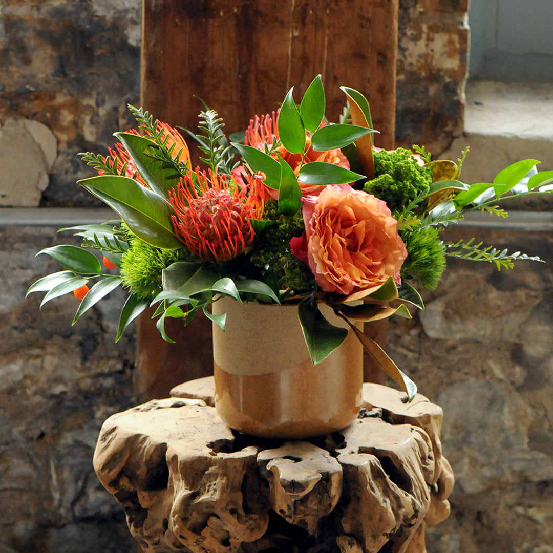 Parkway floral arrangement shown on wood occasional table