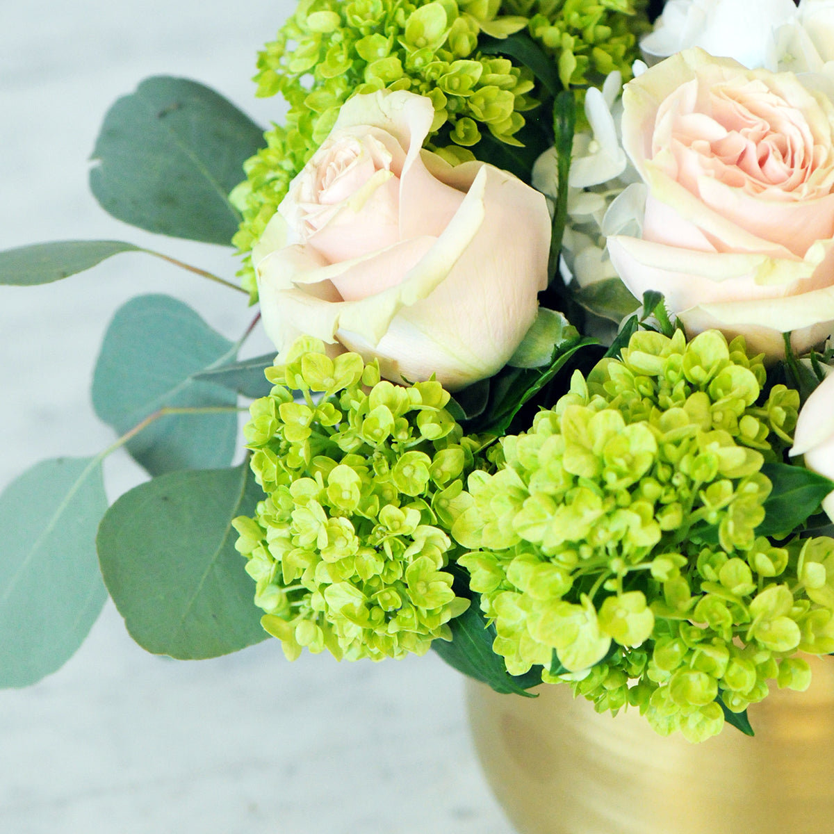 Close up view of Queen arrangement showing soft pink mondial roses