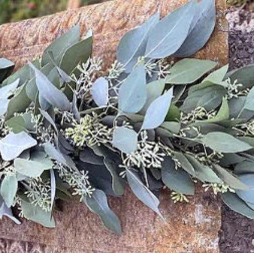 Green leafy garland on a stone surface