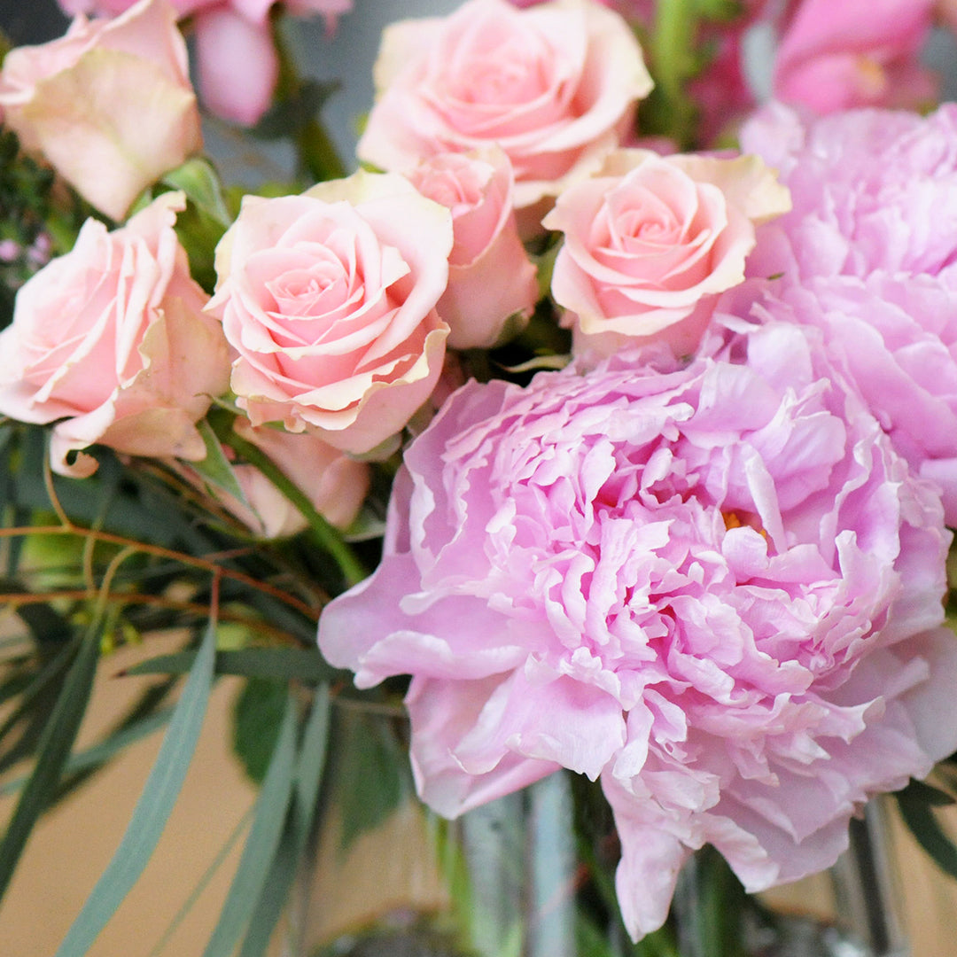 Peonies and pink spray roses in detail