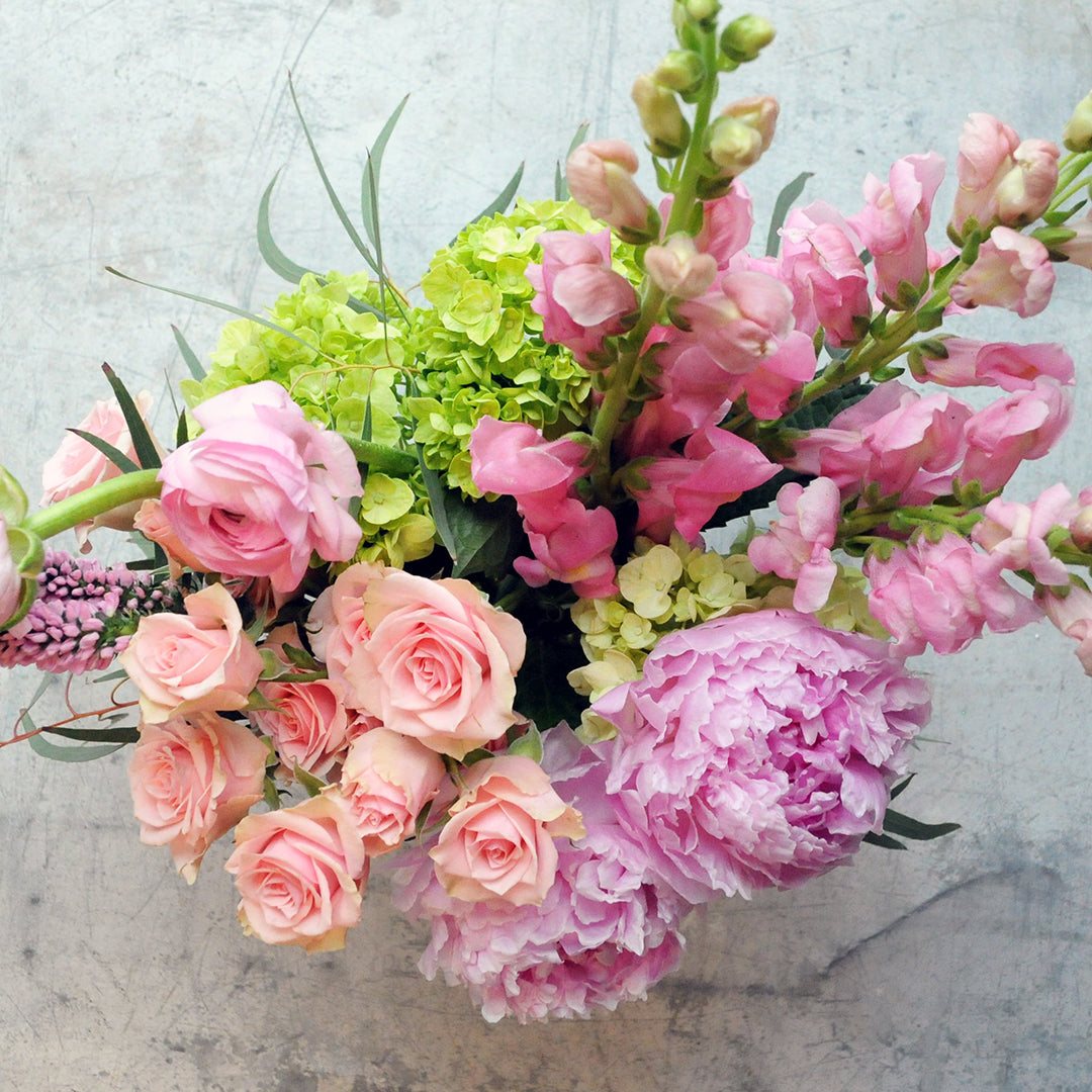 Top down view of floral arrangement in pink and peach tones