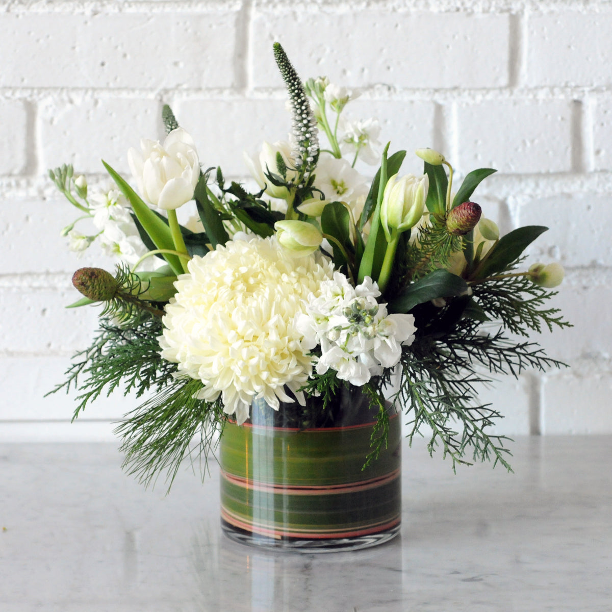 Spruce flowers Aspen arrangement in a glass vase showing its multi colored foliage leaf wrap in a glass vase textural cedar foliage