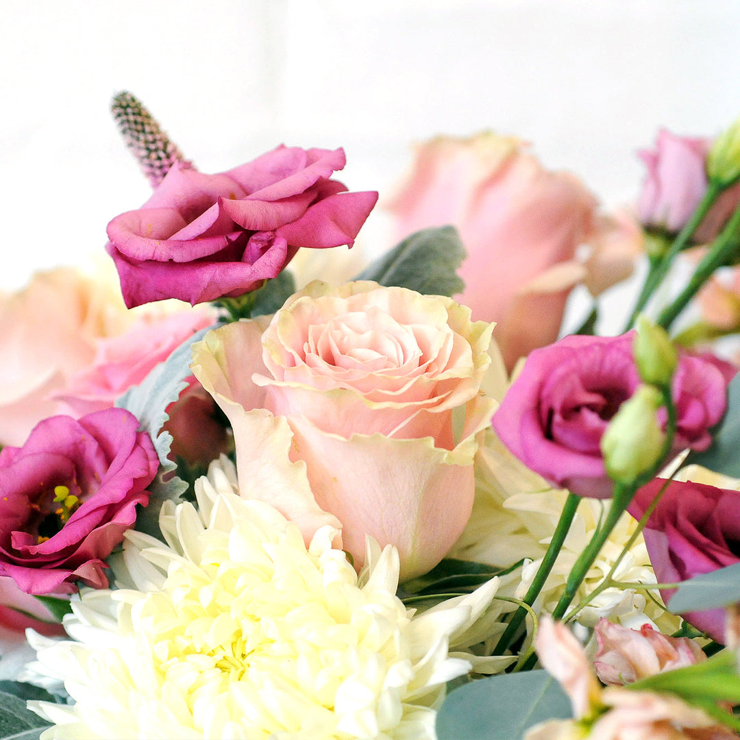 Close up of pink Roses and Lisianthus featured in Spruce Flowers Blaisdell arrangement