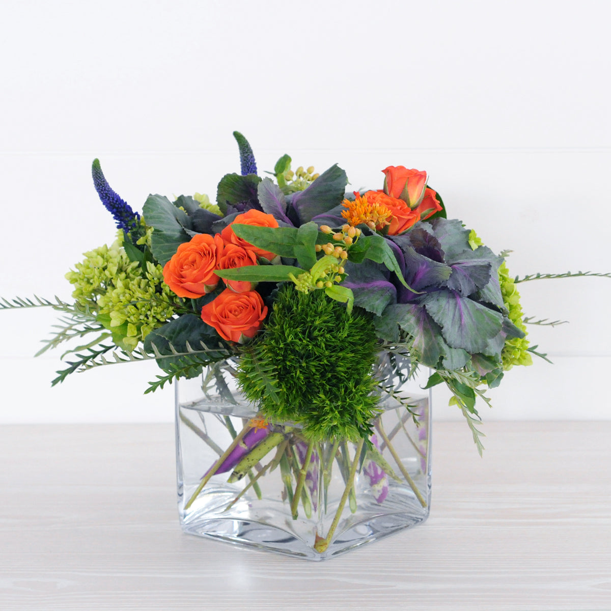 Spruce Flowers designed Bryant arrangement a bouncy blend of Kale, mini greens Orange Spray roses Asclepias and Veronica for delivery in the Minneapolis St Paul metro Area
