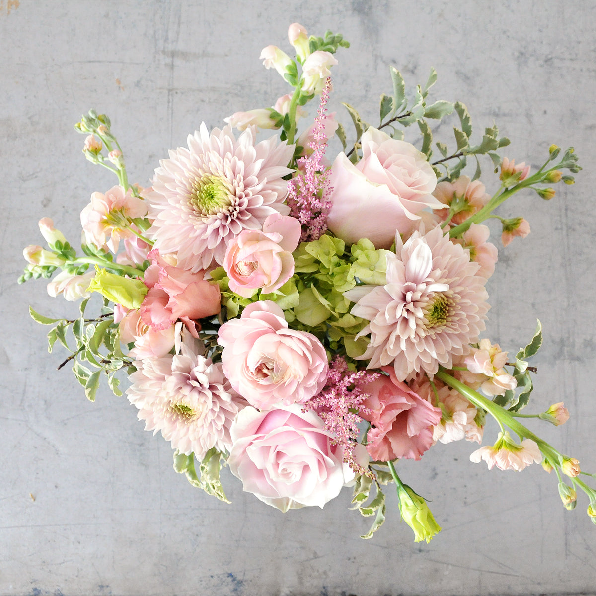Top down view of pastel pink  florals styled Classic Creative Director, image is an example of the styling rather than the exact arrangement that will be sent