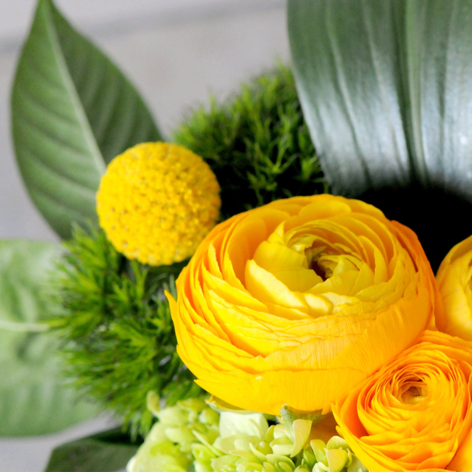 Close of detail of ranunculus flower. Image is an example of the styling rather than the exact arrangement that will be sent