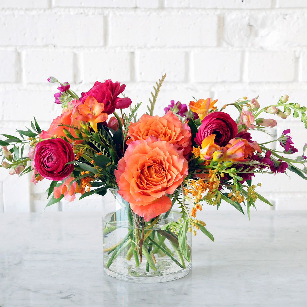 Bright Whimsical Floral arrangement with orange and jewel tones
