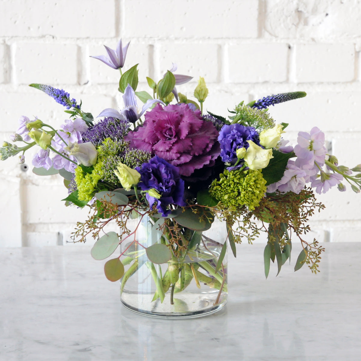 Creative Director Whimsical with purple Kale and lilac Stock with purple Lisianthus
