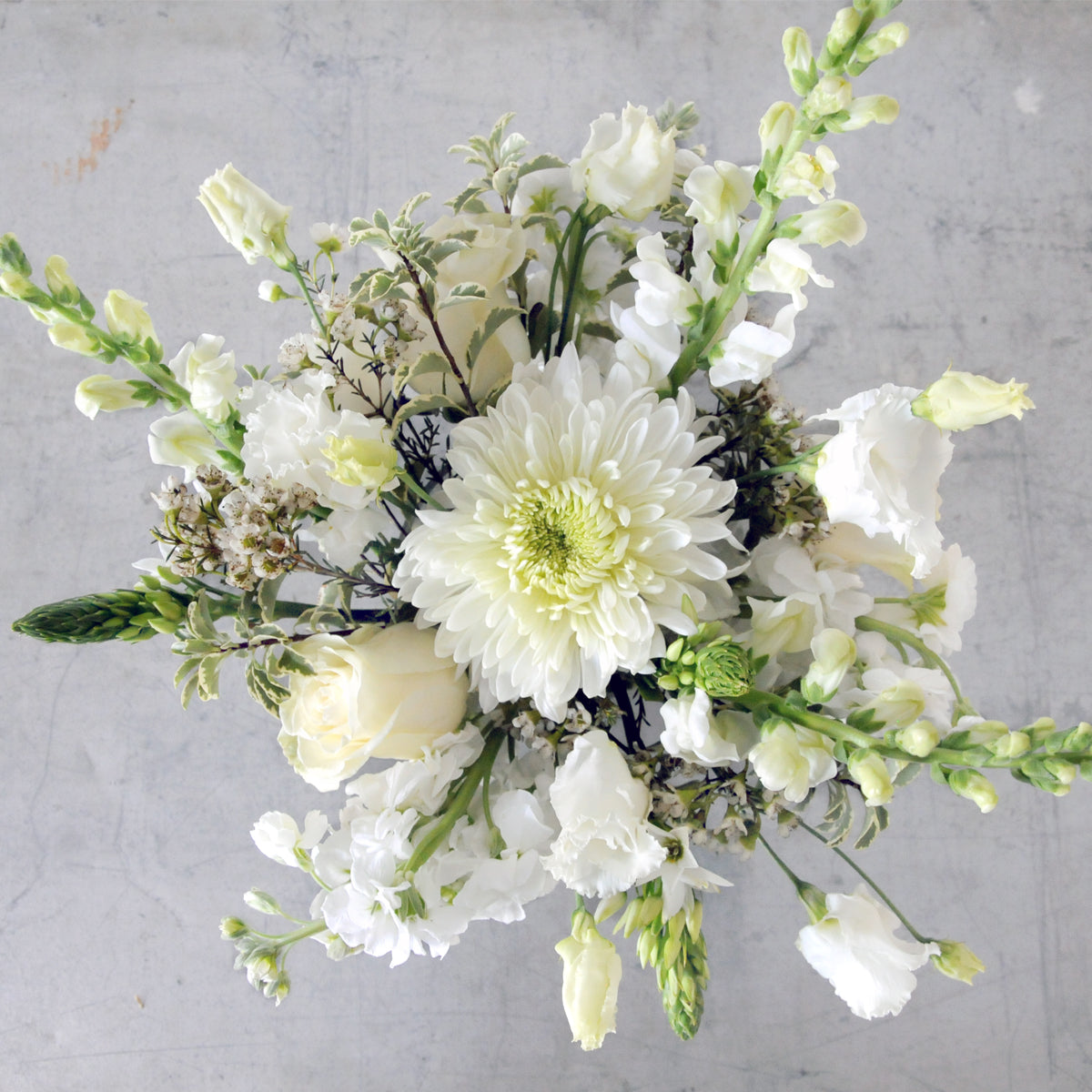 Top down view of a Whimsical Creative Director in White with Fresh Flowers