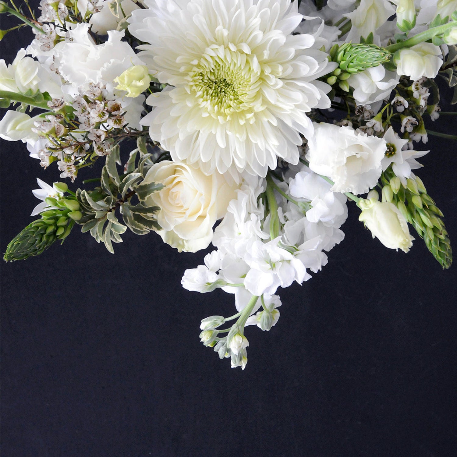 Detailed view of a White Whimsical florals on a black background. Image is an example of the styling rather than the exact arrangement that will be sent