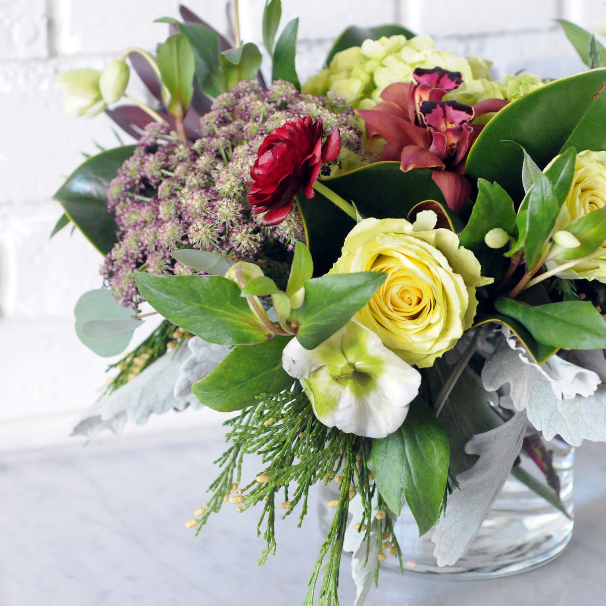 Detailed view of Spruce Flowers Linden arrangement showing its whimsical stying and textural blend of fresh florals anf greens.