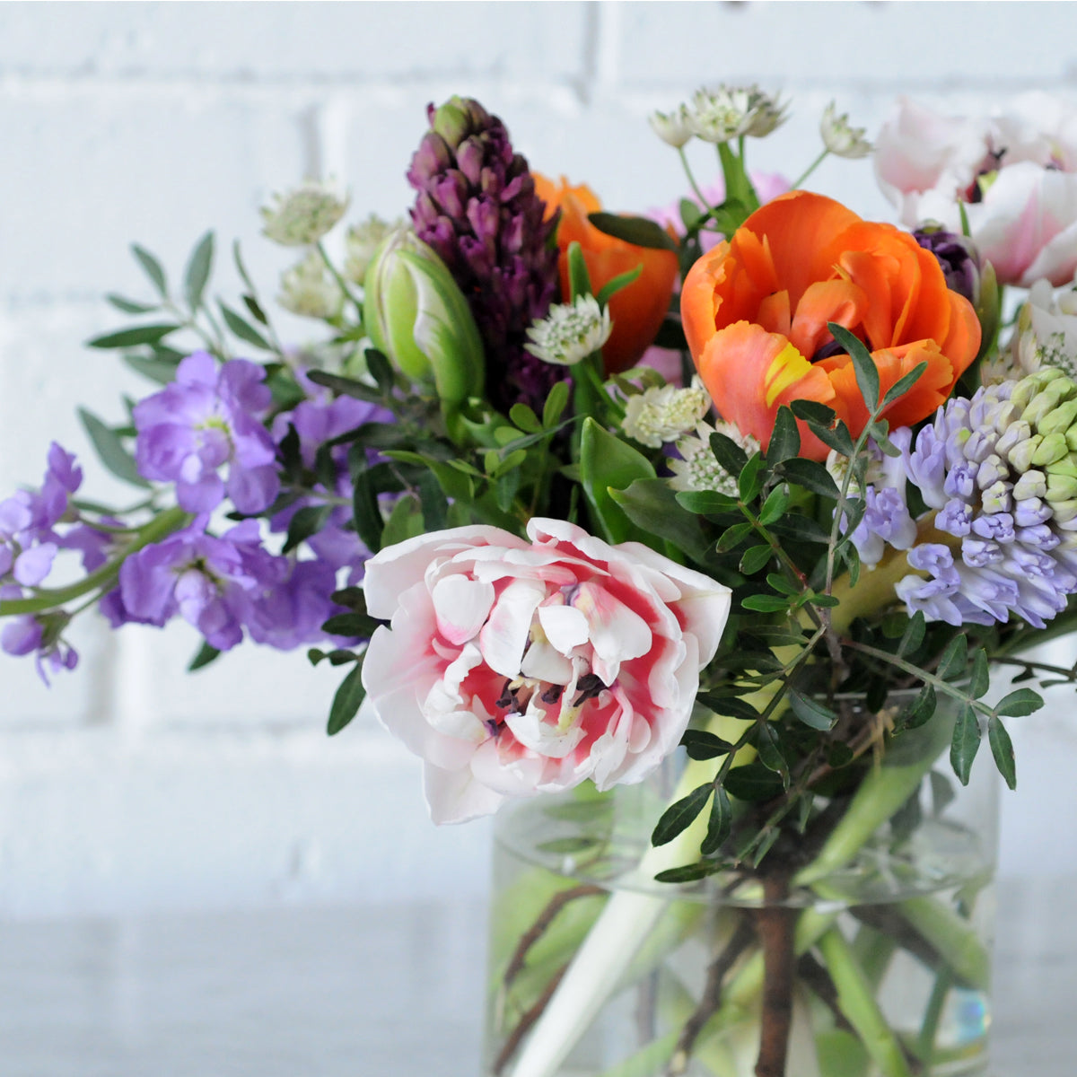 Close up view of the Spring St arrangement from Spruce Flowers a vibrant spring mix of favorites such as tulips and Hyacinth for fresh flower delivery in Minneapolis & St Paul