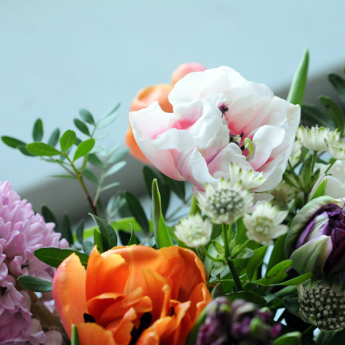 Double Tulips feature in the Spring St arrangement from Spruce Flowers a vibrant spring mix of favorites such as tulips and Hyacinth for fresh flower delivery in Minneapolis & St Paul 