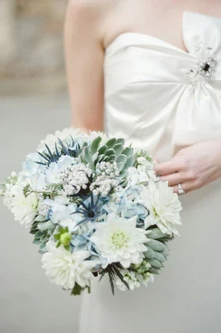 Bride standing with White and green Bridal Bouquet  with Dahlias and sedum 