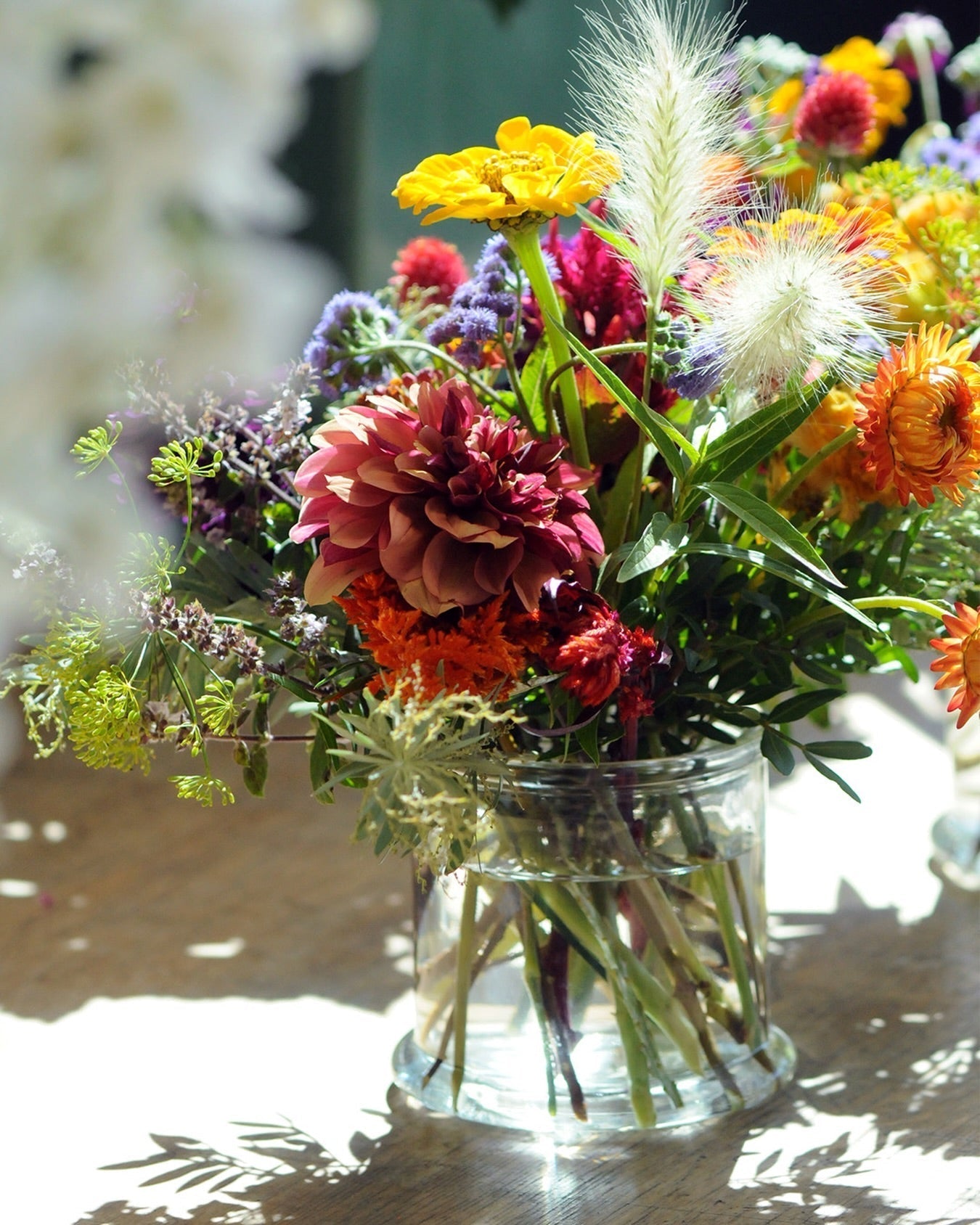 Whimsical Bouquet in glass vase with blurred background 
