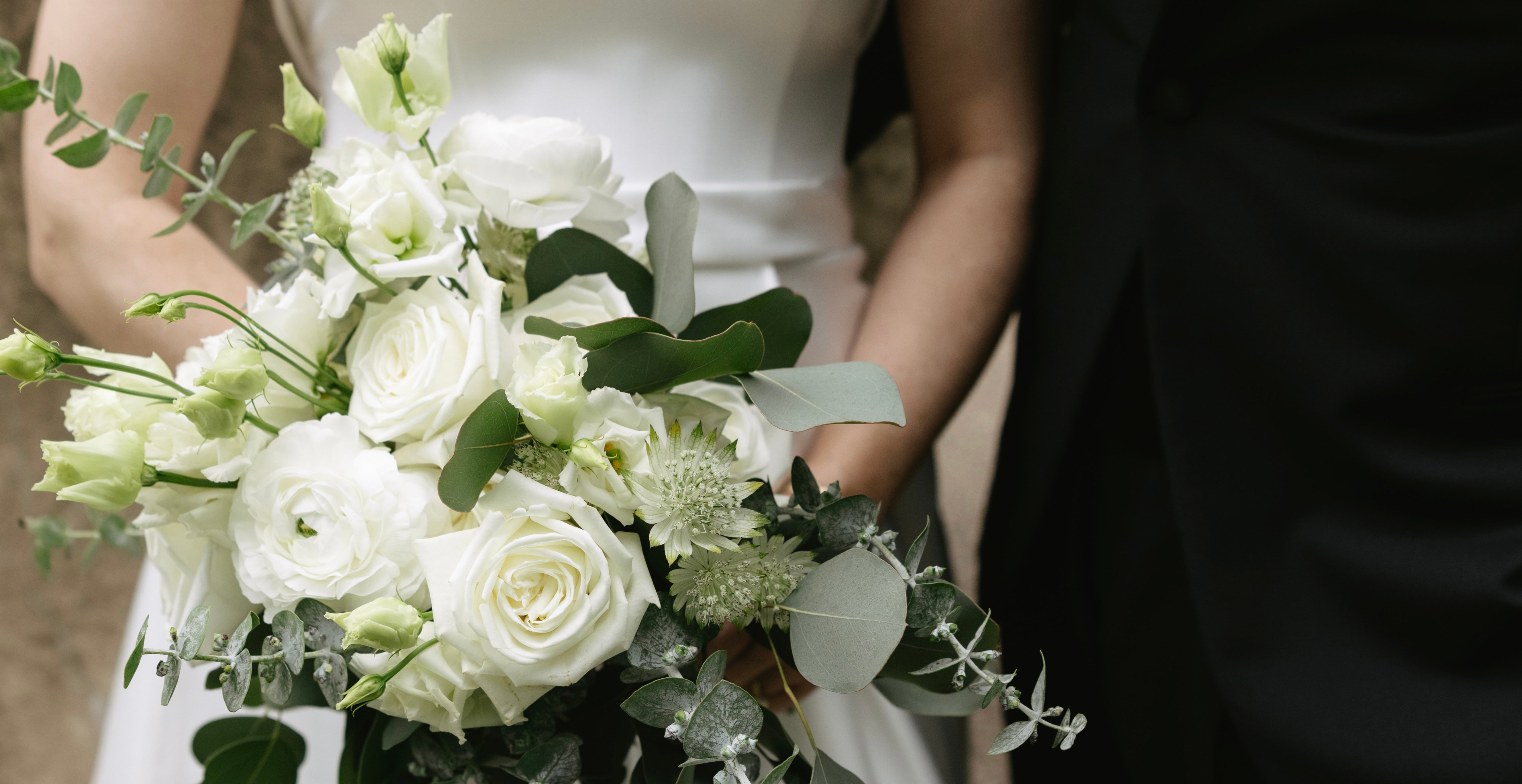 Close up of couple with White Bridal Bouquet from Spruce