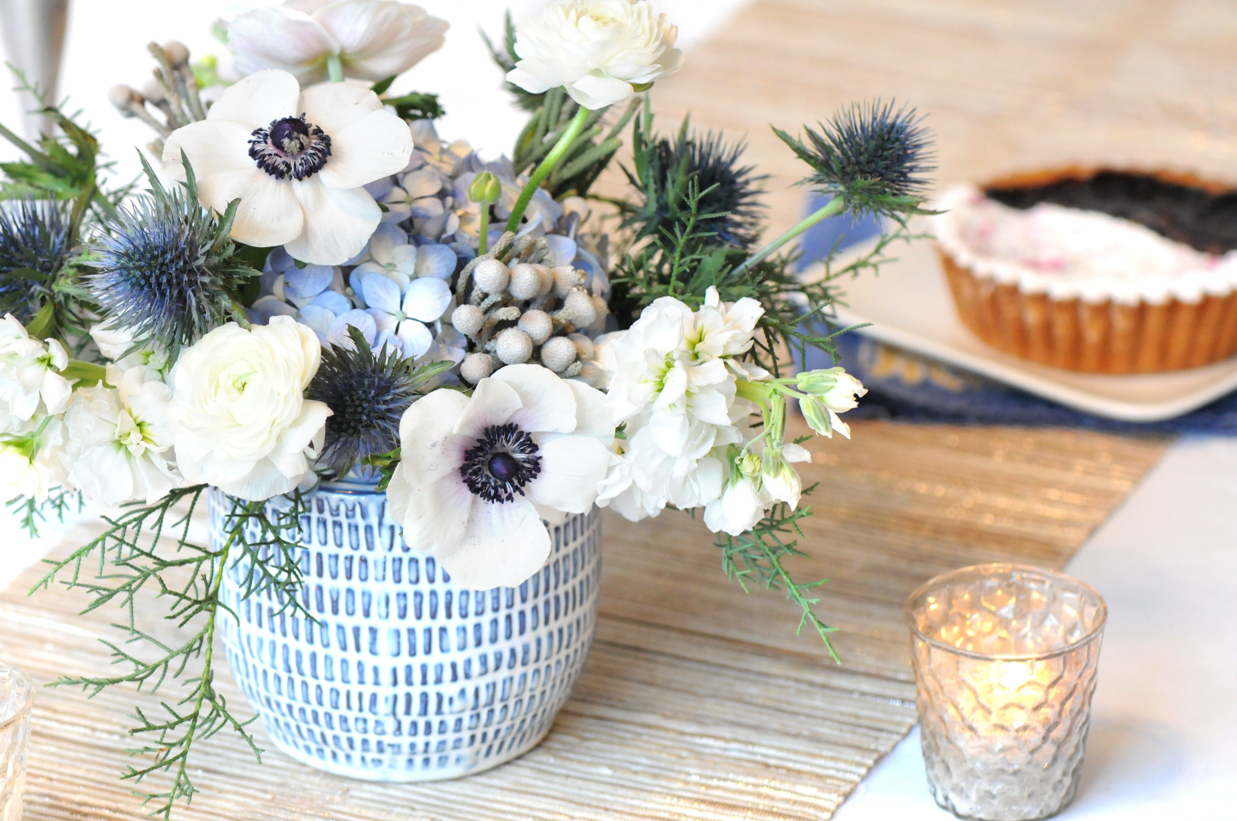 Floral arrangement on table with linens and a pie