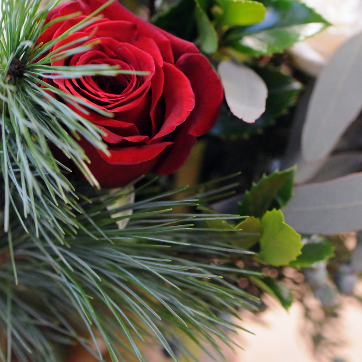 detail photo of holiday greens and flowers 