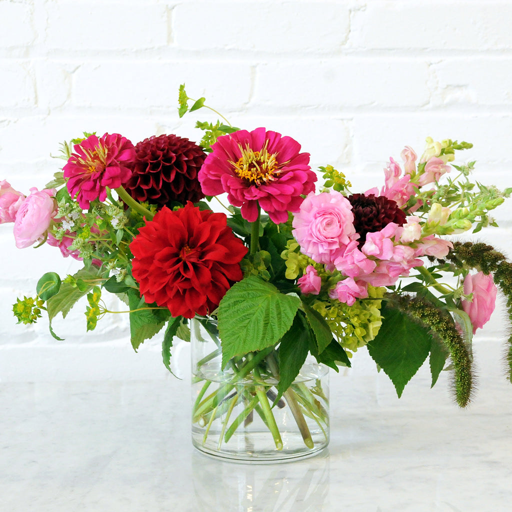 Front View of The Buchanan arrangement from Spruce Flowers Brightly colored bllooms with delicate textural seasonal accents.