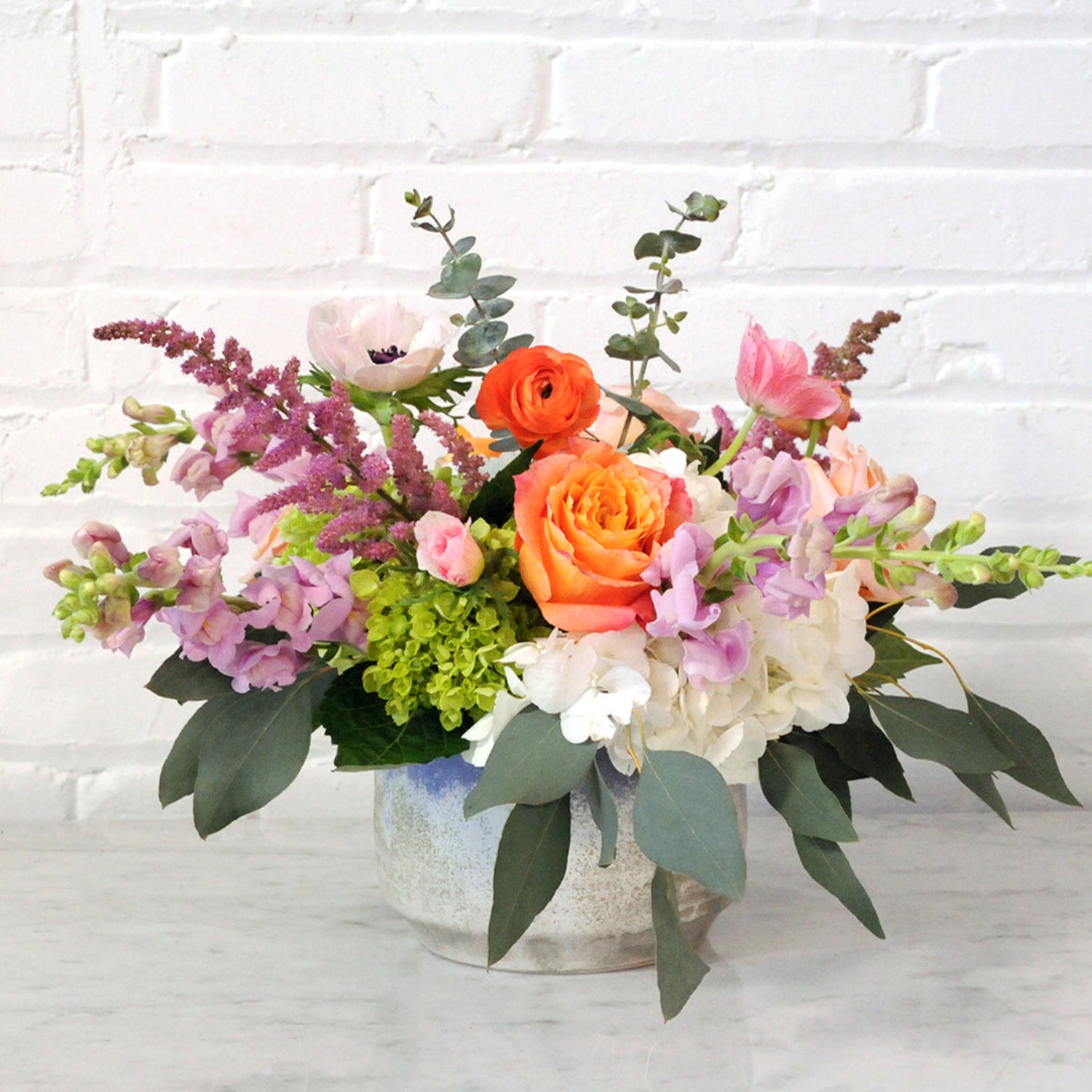 Cheyenne Fresh floral arrangement from Spruce Flowers in a blue and gray ceramic vase 