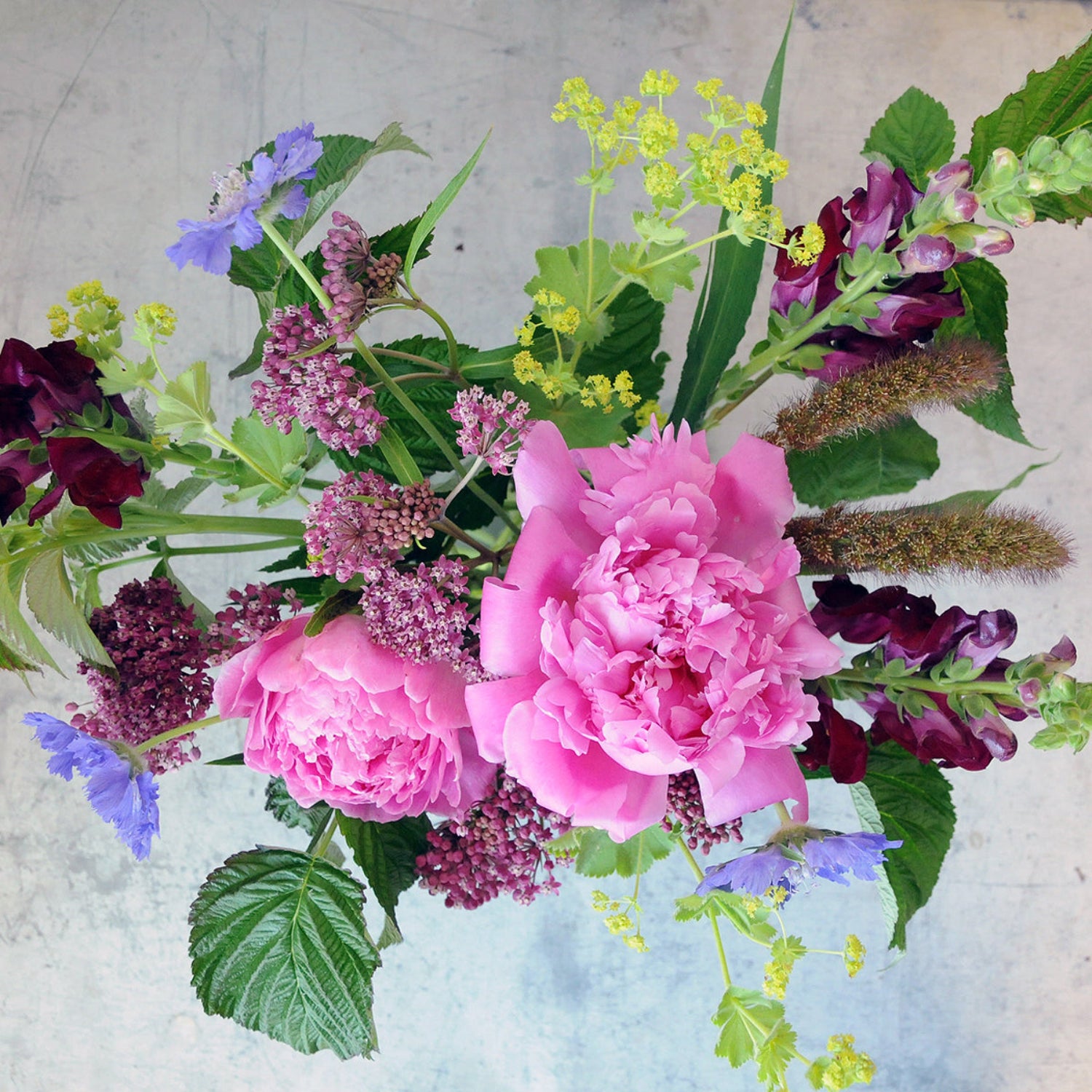 top down view of the larpenteur arrangement highlighting bring pink peonies