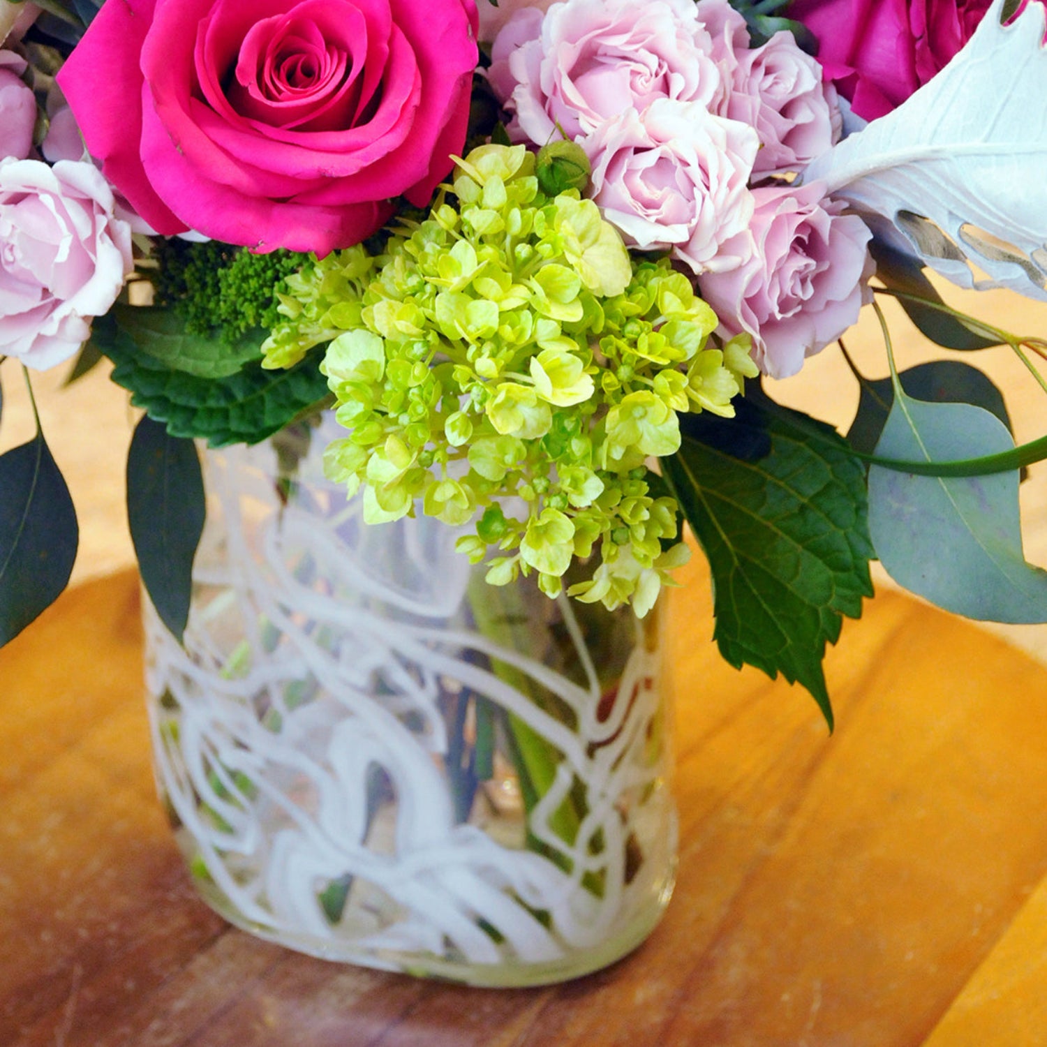 Detail view of roses and green hydrangea in the Edgerton Floral Arrangement