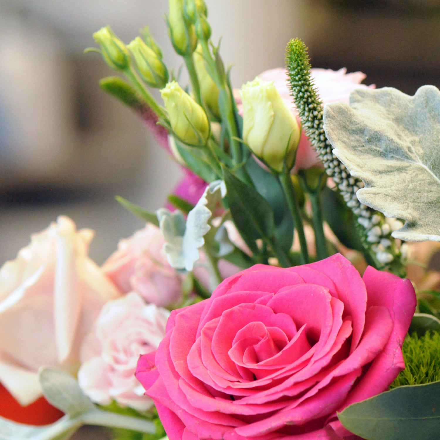 Detail view of roses, lisianthus, and veronica in our Edgerton Arrangement