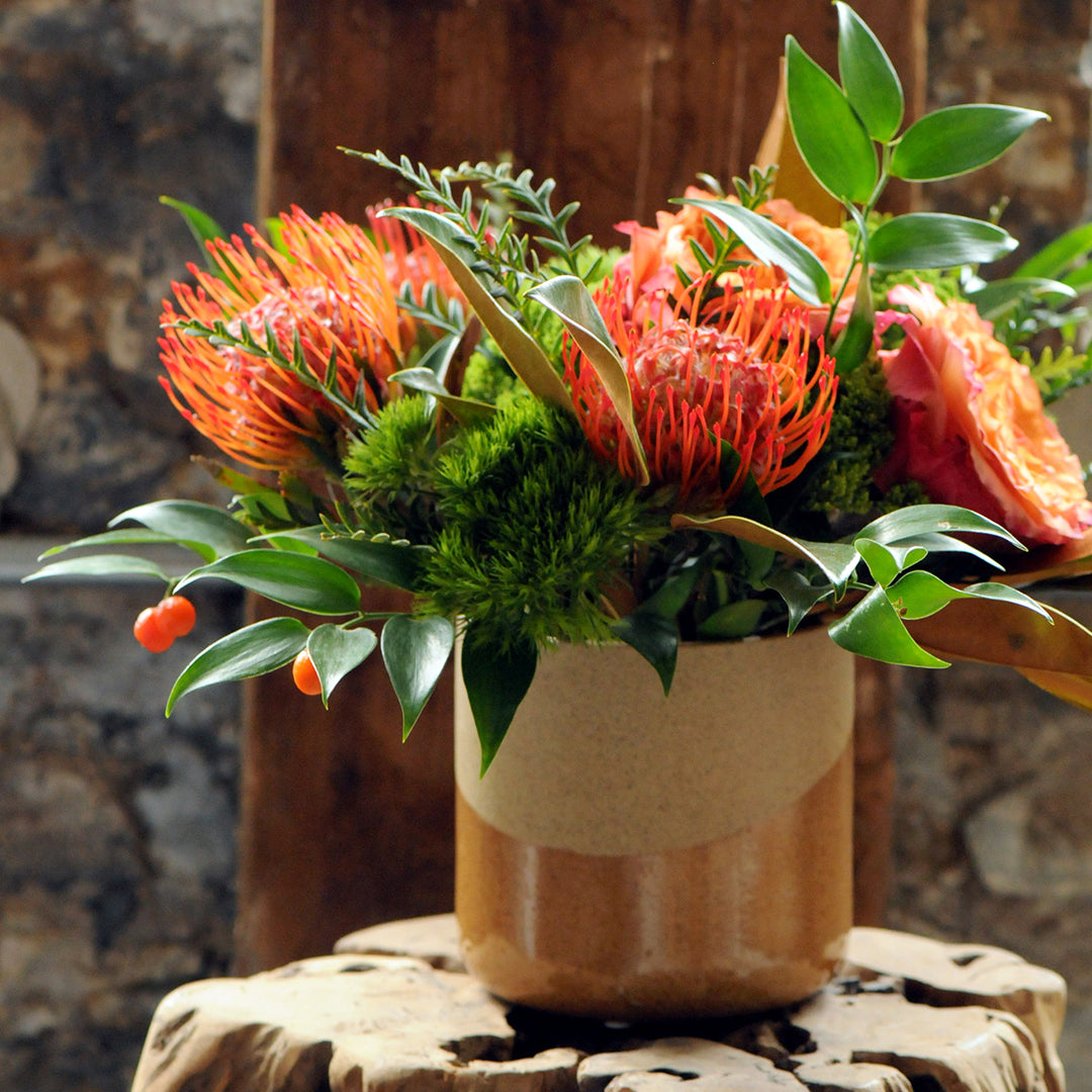 Photo of Tan vase with Parkway Floral arrangement .