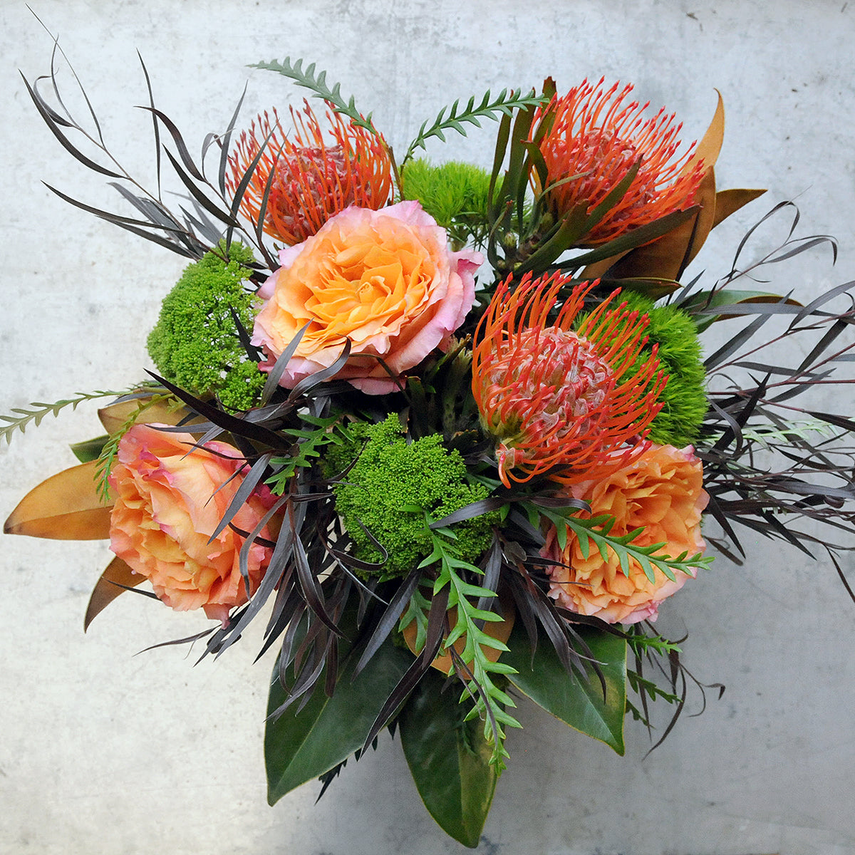 Top down view of Parkway Floral arrangement Showing it's textured Foliages with rich autumn tones 