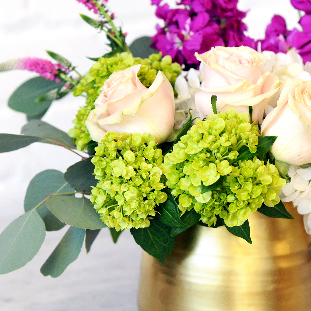 Close up detailed view of Spruce Flowers queen arrangement showing the texture of the gold tegan ceramic and Mini Green Hydrangea 