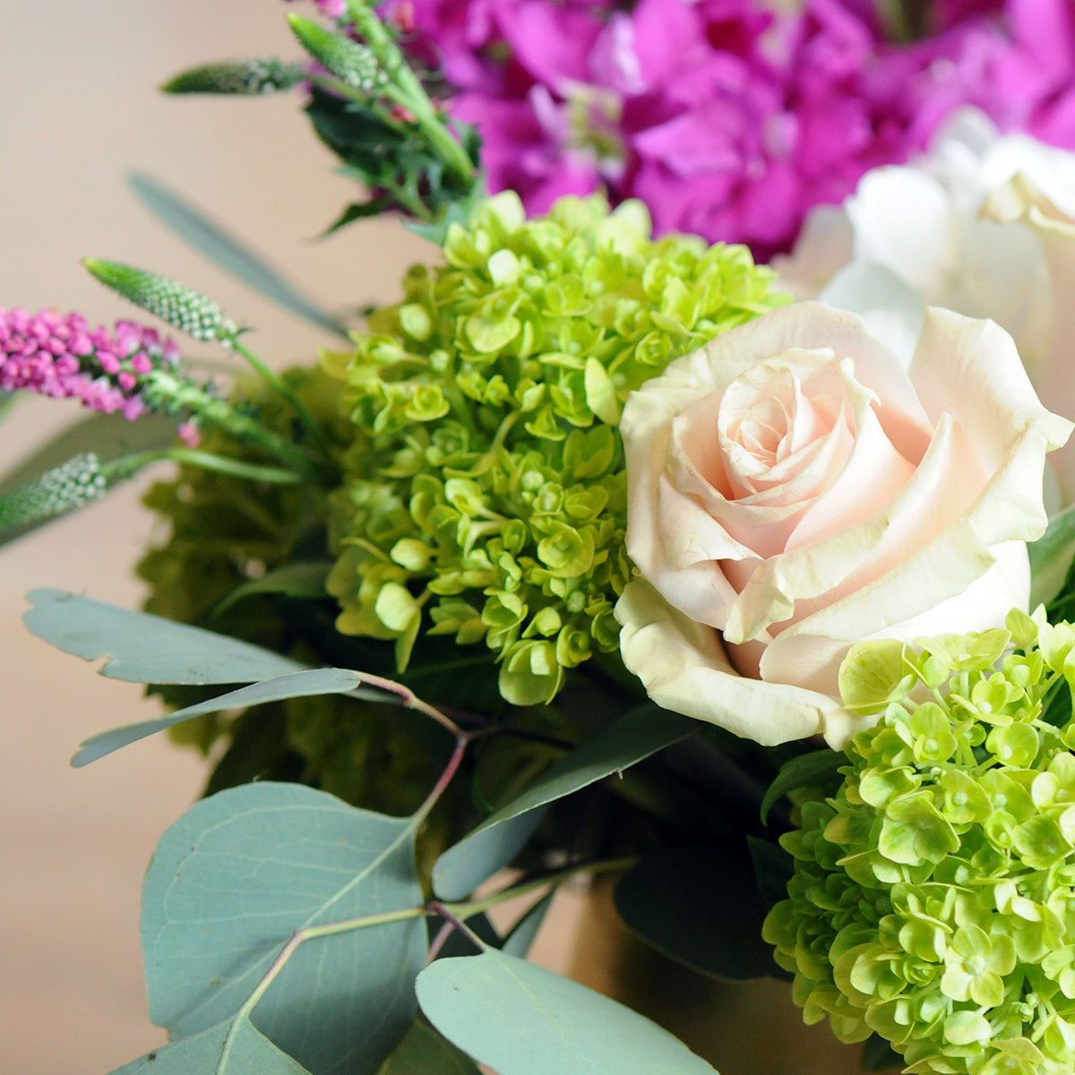 Close up of Queen arrangement showing Hydrangea Roses and foliage 