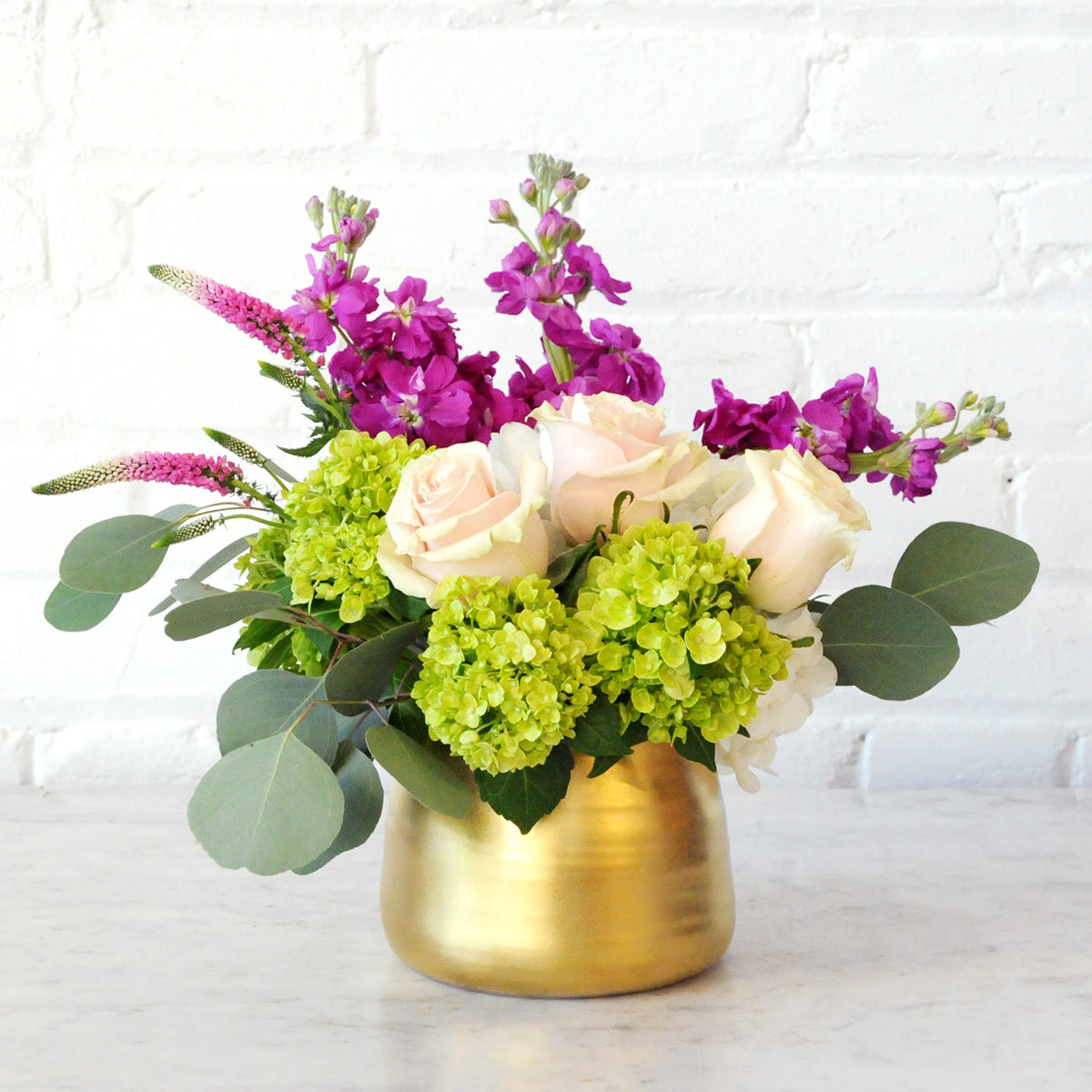 Spruce Flowers: Queen arrangement in a Gold Tegan vase with White Hydrangea and mini green hydrangea , Soft Pink Roses and scented hot pink stock