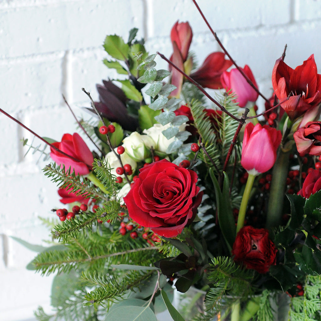 Side angle photo of armatage flower arrangement featuring roses and tulips
