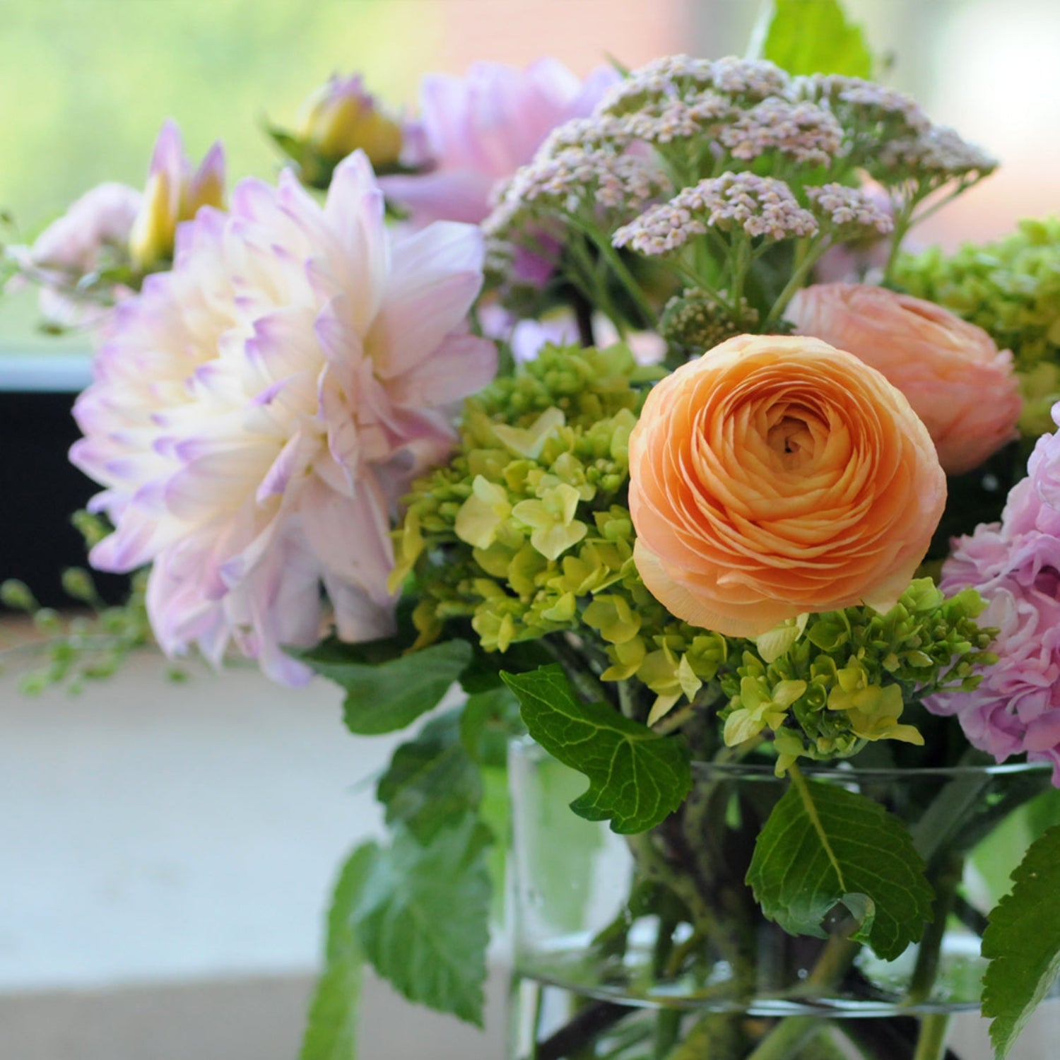 Dahlias, Ranunculus and yarrow making guest appearances in our Buchanan arrangement   