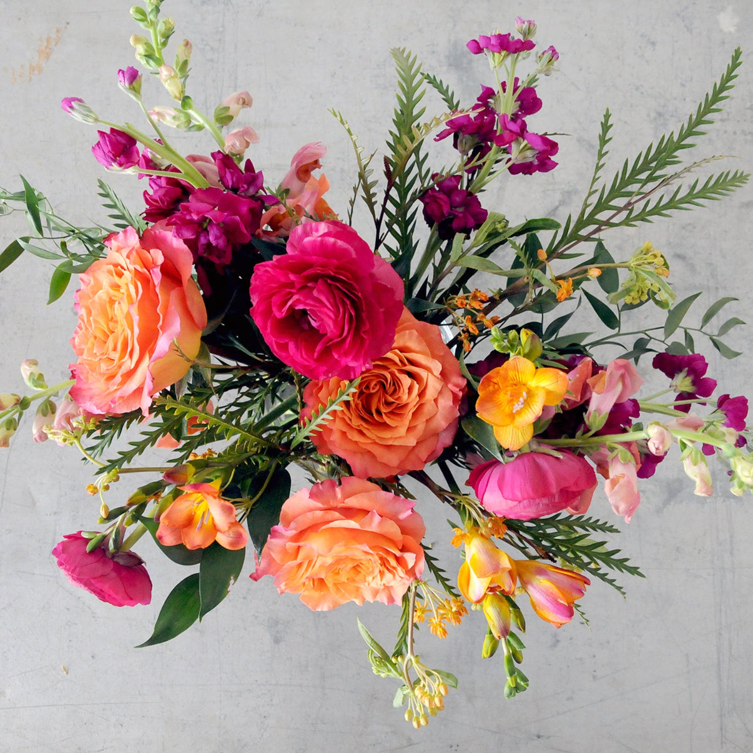 Top down view of a bright Whimsical Creative Director floral arrangement from Spruce Flowers. Image is an example of the styling rather than the exact arrangement that will be sent 