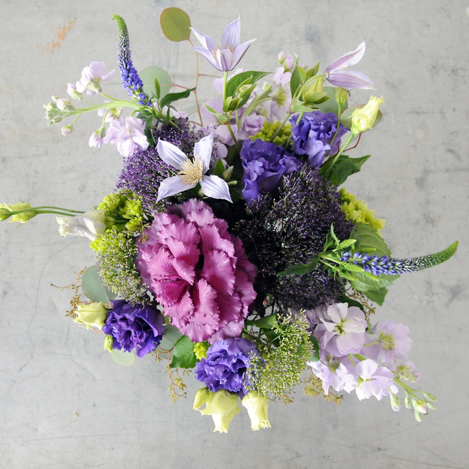 Top down view of Whimsical creative Director in Purple tones. Image is an example of the styling rather than the exact arrangement that will be sent 
