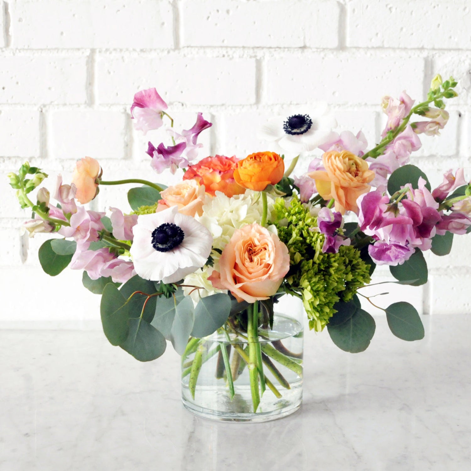 Spruce Flowers Cheyenne pastel fresh floral arrangement in a glass cylinder vase 