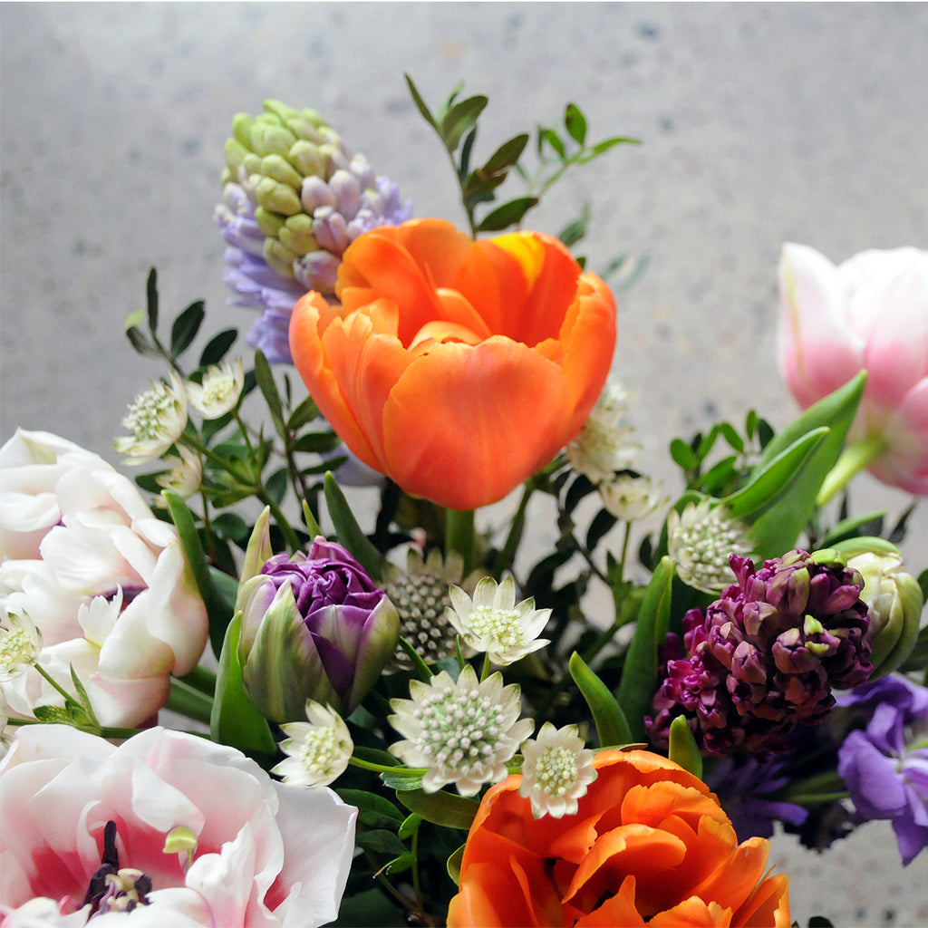 Flowers featured in this view of the Spring St arrangement from Spruce Flowers are a vibrant spring favorites such as Double tulips and Hyacinth for fresh flower delivery in Minneapolis & St Paul 