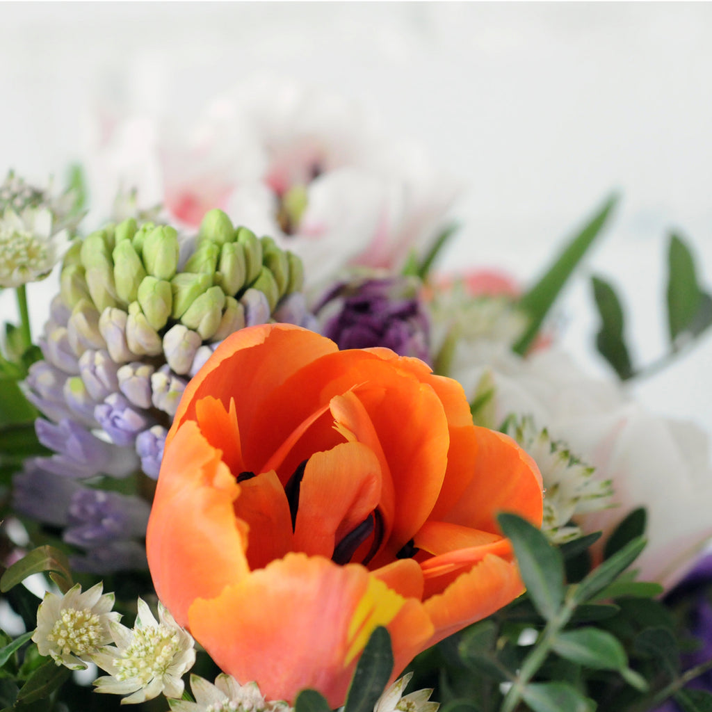 Close up  view of the Spring St arrangement from Spruce Flowers a vibrant spring mix of favorites such as tulips and Hyacinth for fresh flower delivery in Minneapolis & St Paul 